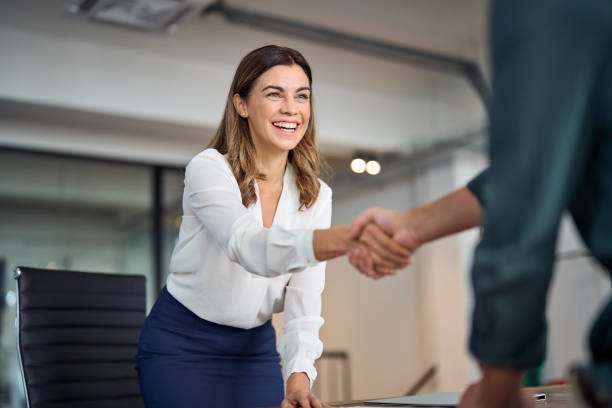 web design agency birmingham. A client is shaking hand happily after Good turnover.